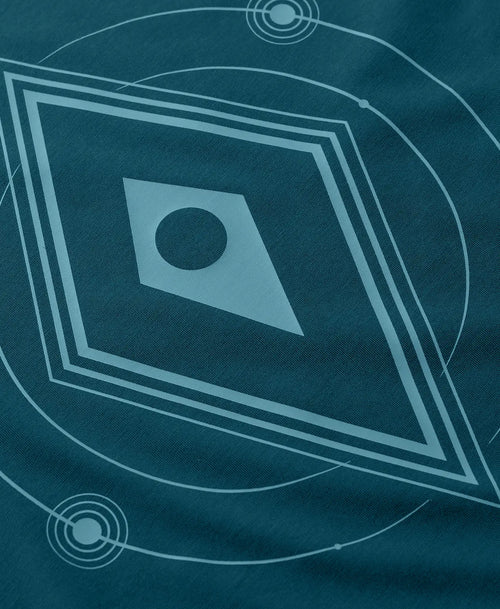 A close-up of a dark teal t-shirt featuring a light blue No Mans Sky logo.